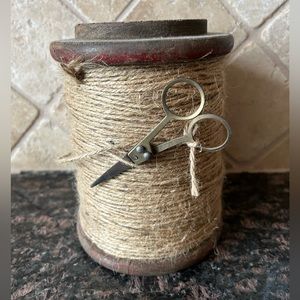 Wooden spool with jute twine and scissors